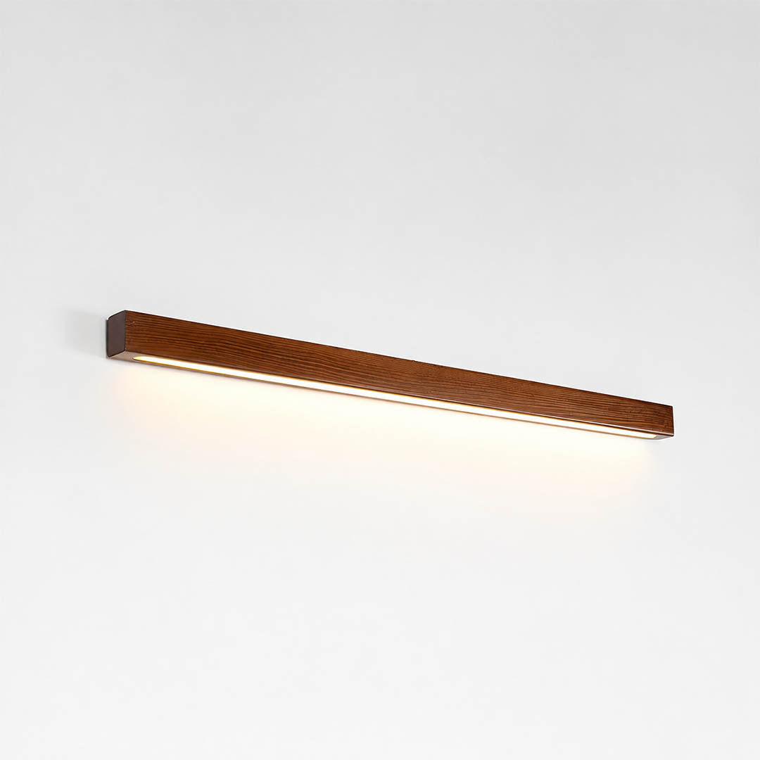 Larsson linear wood wall light walnut color wood integrated LED warm glow slim linear bar white background front view
