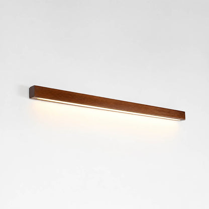 Larsson linear wood wall light walnut color wood integrated LED warm glow slim linear bar white background front view