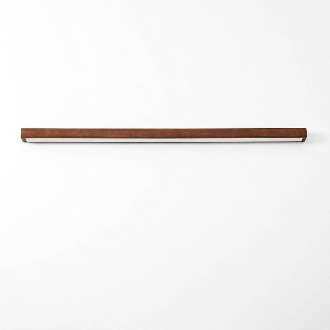 Larsson linear wood wall light walnut color wood integrated LED warm glow slim linear bar white background front view