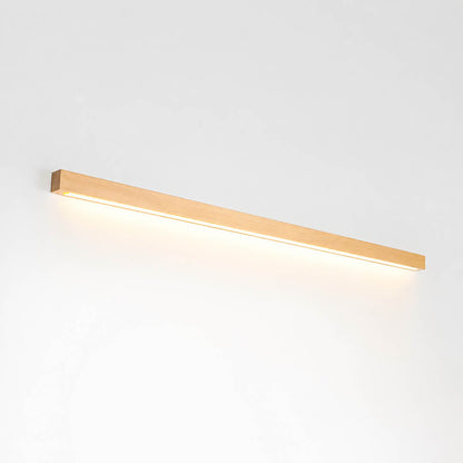 Larsson linear wood wall light natural pine wood color integrated LED warm glow slim bar white background front view
