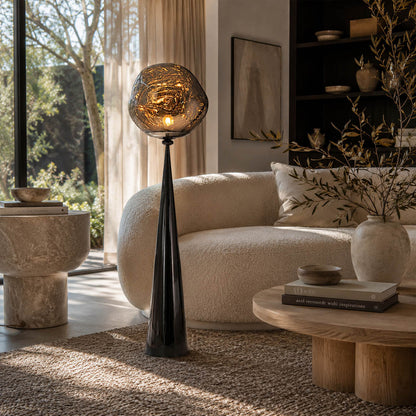 Lava sculptural floor lamp modern living room beside sofa gold metallic molten statement ambient American home lifestyle interior