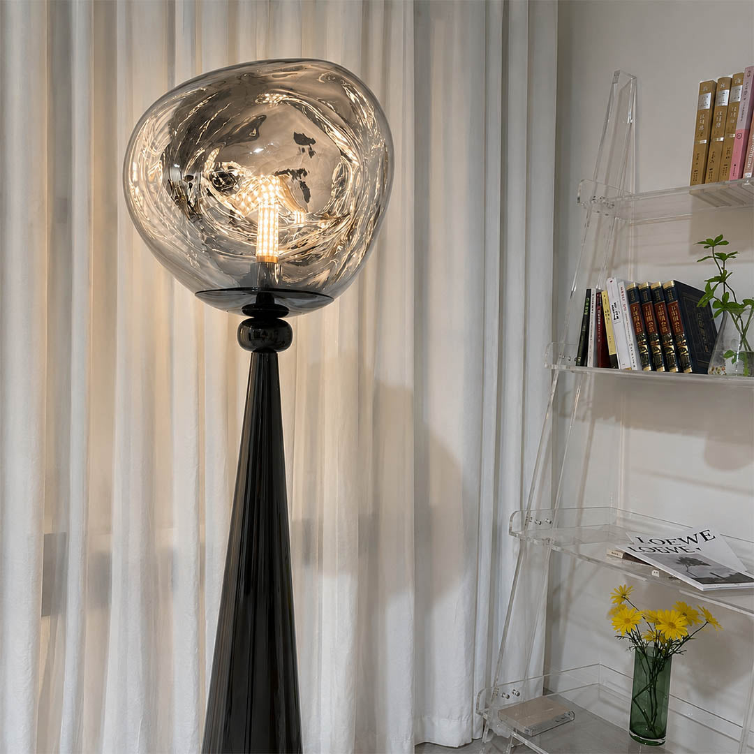 Lava sculptural floor lamp illuminated ethereal molten glow twisted metallic shade dreamy ambient evening mood detail close up