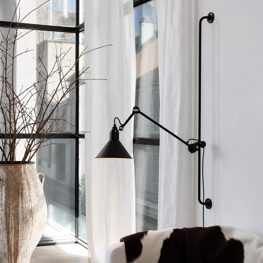 Leva swing arm wall sconce as an adjustable accent beside a modern living room sofa