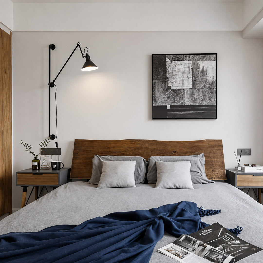 Pair of Leva swing arm wall sconces mounted above nightstands for adjustable bedside reading light