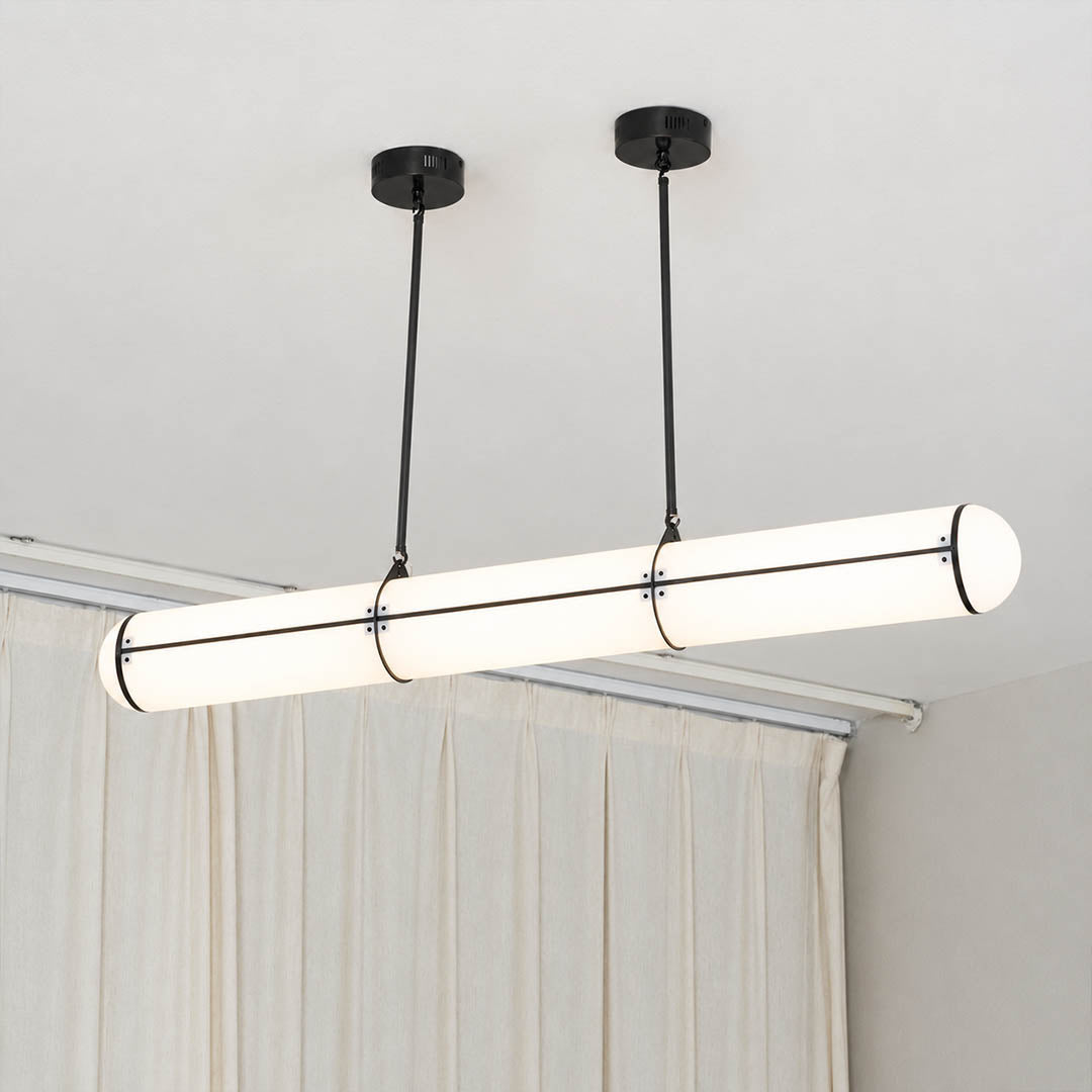 Linea pendant light brass metal slim band frame refined detail architectural fasteners polished finish close up sophisticated modern