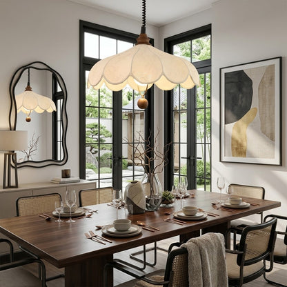 Linen drum pendant light above dining table warm soft glow modern farmhouse interior