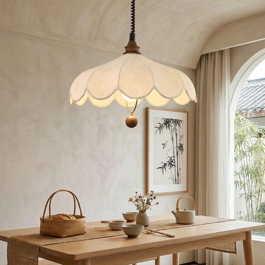 Linen drum pendant light above dining table warm soft glow modern farmhouse interior