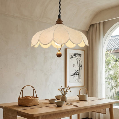 Linen drum pendant light above dining table warm soft glow modern farmhouse interior