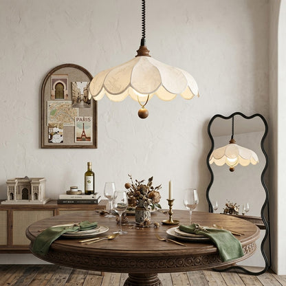 Linen drum pendant light above dining table warm soft glow modern farmhouse interior