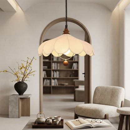 Linen drum pendant light above dining table warm soft glow modern farmhouse interior