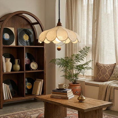 Linen drum pendant light above bedroom or living room warm ambient glow