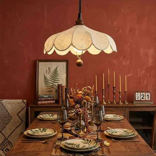 Linen drum pendant light above dining table warm soft glow modern farmhouse interior