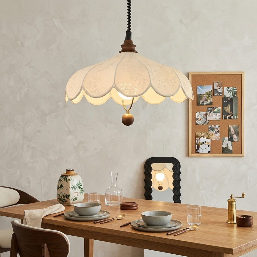 Linen drum pendant light above dining table warm soft glow modern farmhouse interior