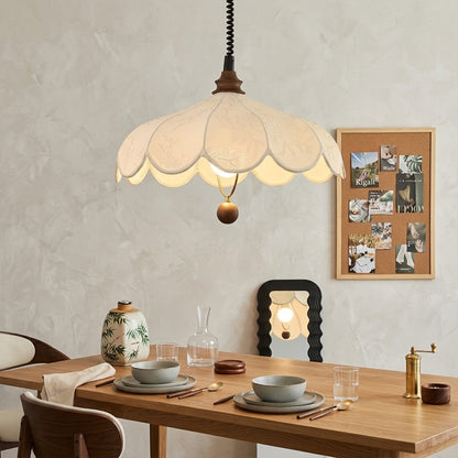Linen drum pendant light above dining table warm soft glow modern farmhouse interior