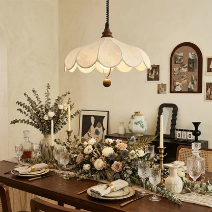 Linen drum pendant light above bedroom or living room warm ambient glow