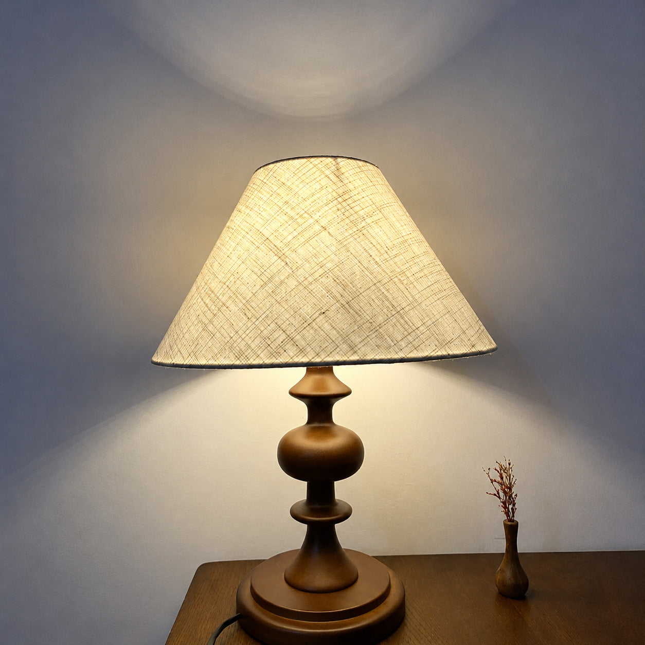 Linnea fabric table lamp illuminated warm ambient glow printed fabric shade wood cozy white background