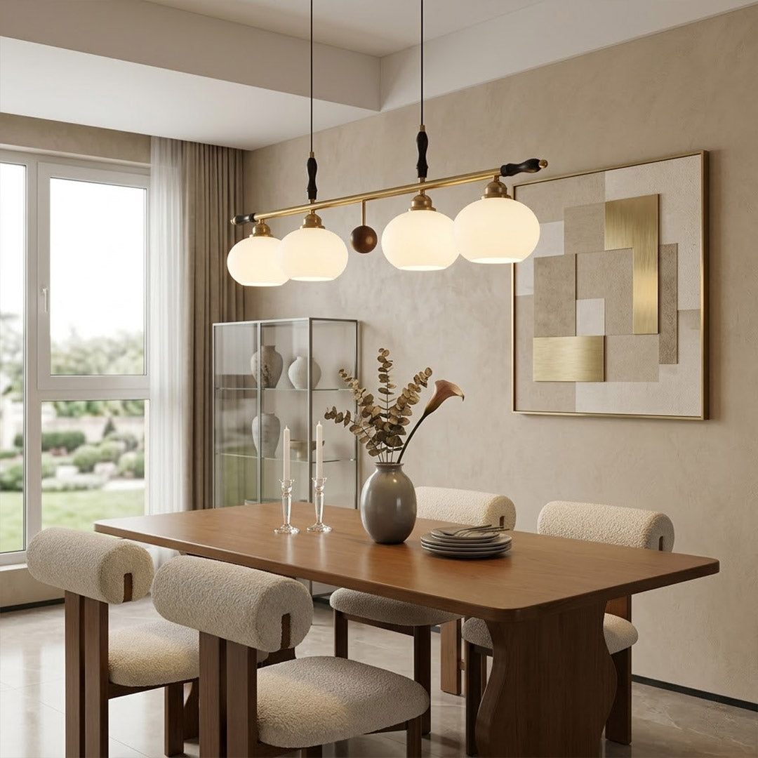 Linora gold linear pendant light above kitchen island warm ribbed glass globe glow organic modern interior