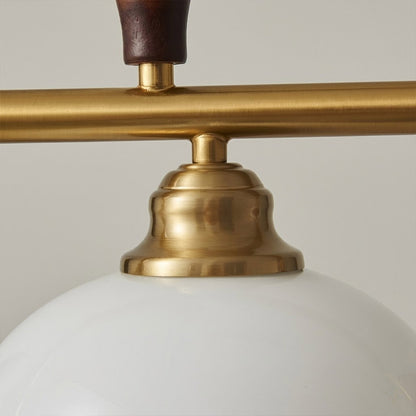 Linora gold linear pendant light above kitchen island warm ribbed glass globe glow organic modern interior