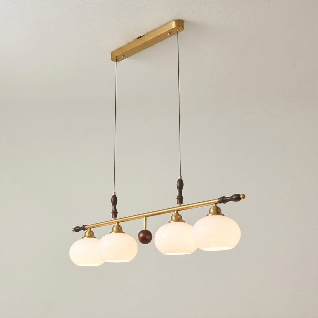 Linora gold linear pendant light above kitchen island warm ribbed glass globe glow organic modern interior