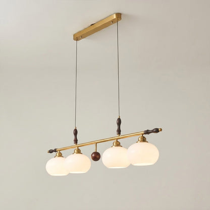 Linora gold linear pendant light above kitchen island warm ribbed glass globe glow organic modern interior