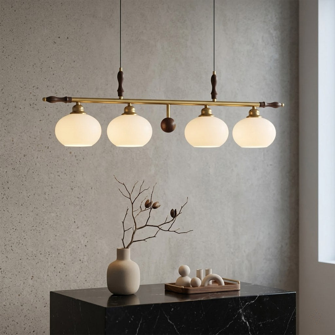Linora gold linear pendant light above kitchen island warm ribbed glass globe glow organic modern interior