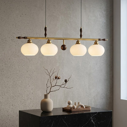 Linora gold linear pendant light above kitchen island warm ribbed glass globe glow organic modern interior