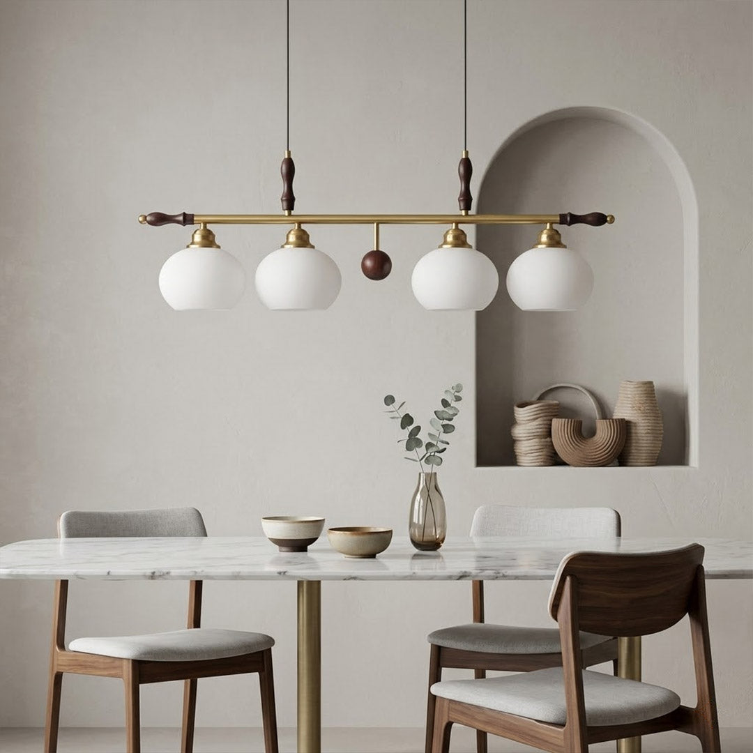 Linora gold linear pendant light above kitchen island warm ribbed glass globe glow organic modern interior