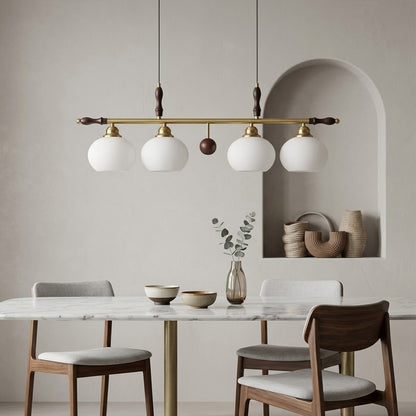 Linora gold linear pendant light above kitchen island warm ribbed glass globe glow organic modern interior