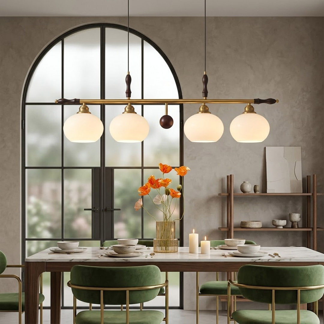 Linora gold linear pendant light above kitchen island warm ribbed glass globe glow organic modern interior