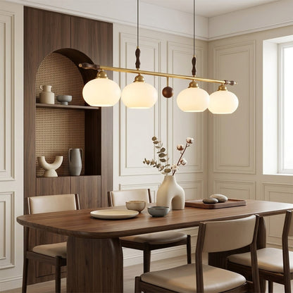 Linora gold linear pendant light above kitchen island warm ribbed glass globe glow organic modern interior