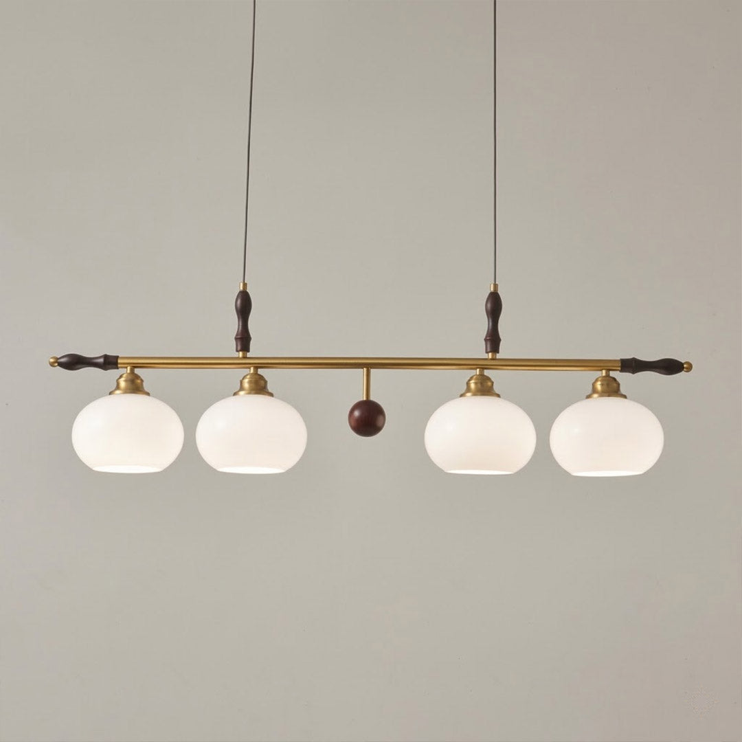 Linora gold linear pendant light above kitchen island warm ribbed glass globe glow organic modern interior