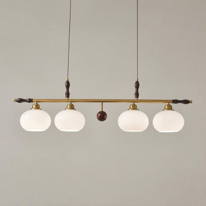 Linora gold linear pendant light above kitchen island warm ribbed glass globe glow organic modern interior