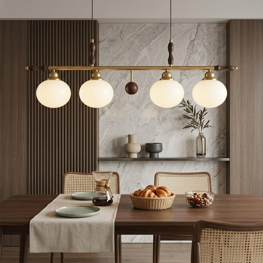 Linora gold linear pendant light above kitchen island warm ribbed glass globe glow organic modern interior