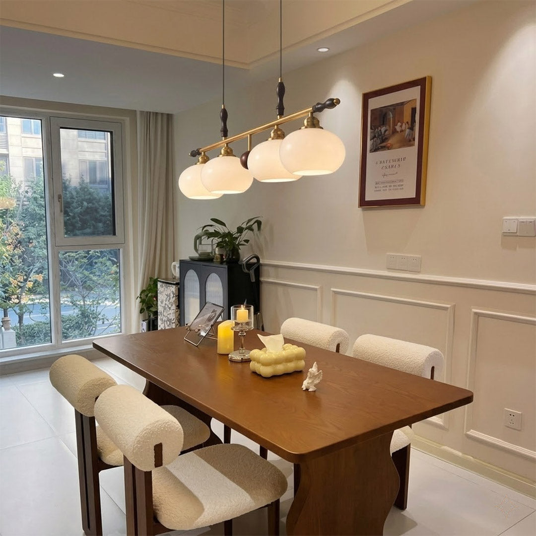 Linora gold linear pendant light above kitchen island warm ribbed glass globe glow organic modern interior