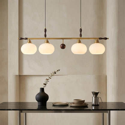 Linora gold linear pendant light above kitchen island warm ribbed glass globe glow organic modern interior