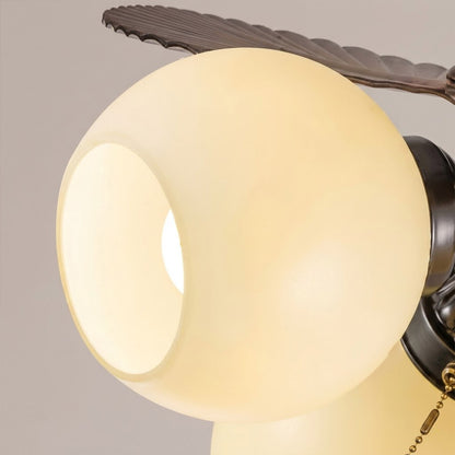 Lotus vintage ceiling fan-A with light above bed warm glass shade glow bedroom interior