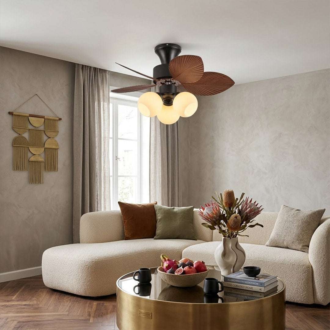 Lotus vintage ceiling fan-A with light above bed warm glass shade glow bedroom interior