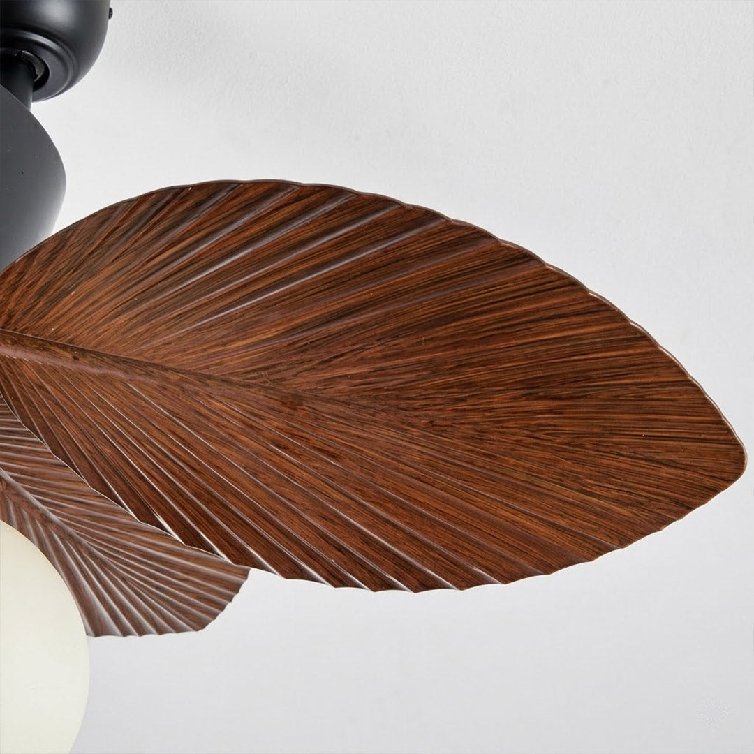 Lotus vintage ceiling fan with light above bed warm glass shade glow bedroom interior