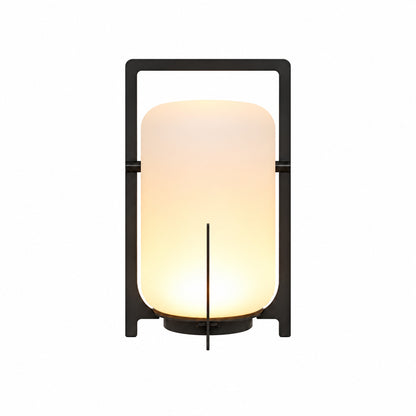 Lucciola rechargeable lantern with a warm glow standing cordless on an outdoor patio table