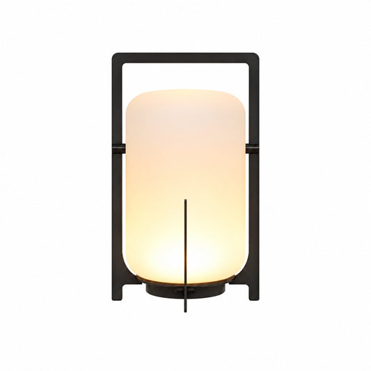 Lucciola rechargeable lantern with a warm glow standing cordless on an outdoor patio table