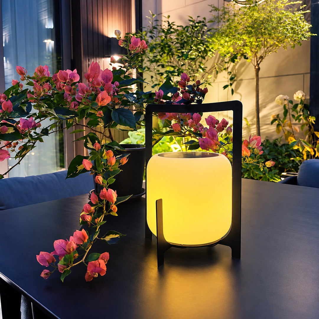 Lucciola rechargeable lantern as a cordless warm centerpiece on an indoor dining table