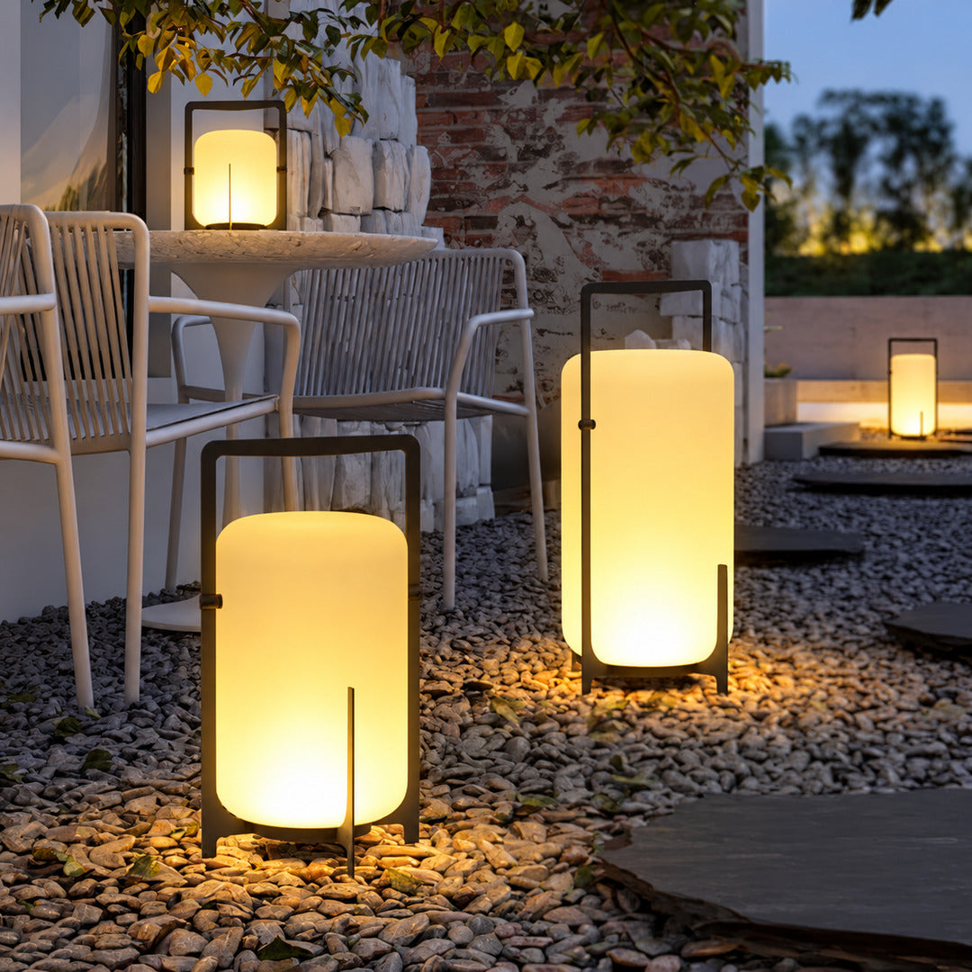 Lucciola rechargeable lanterns lining an outdoor dining table for an evening gathering