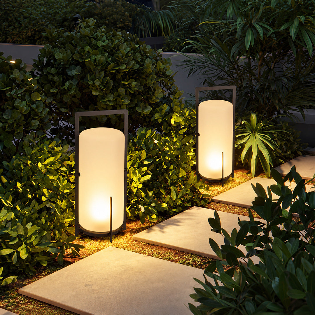 Lucciola rechargeable lantern lighting a garden seating area with a soft warm glow
