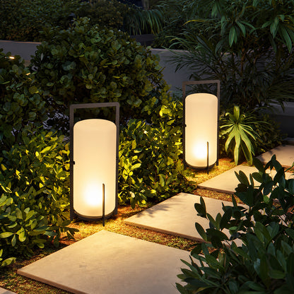 Lucciola rechargeable lantern lighting a garden seating area with a soft warm glow