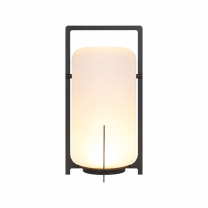 Large 21.3-inch black Lucciola rechargeable floor lantern with a glass shade beside a lounge chair