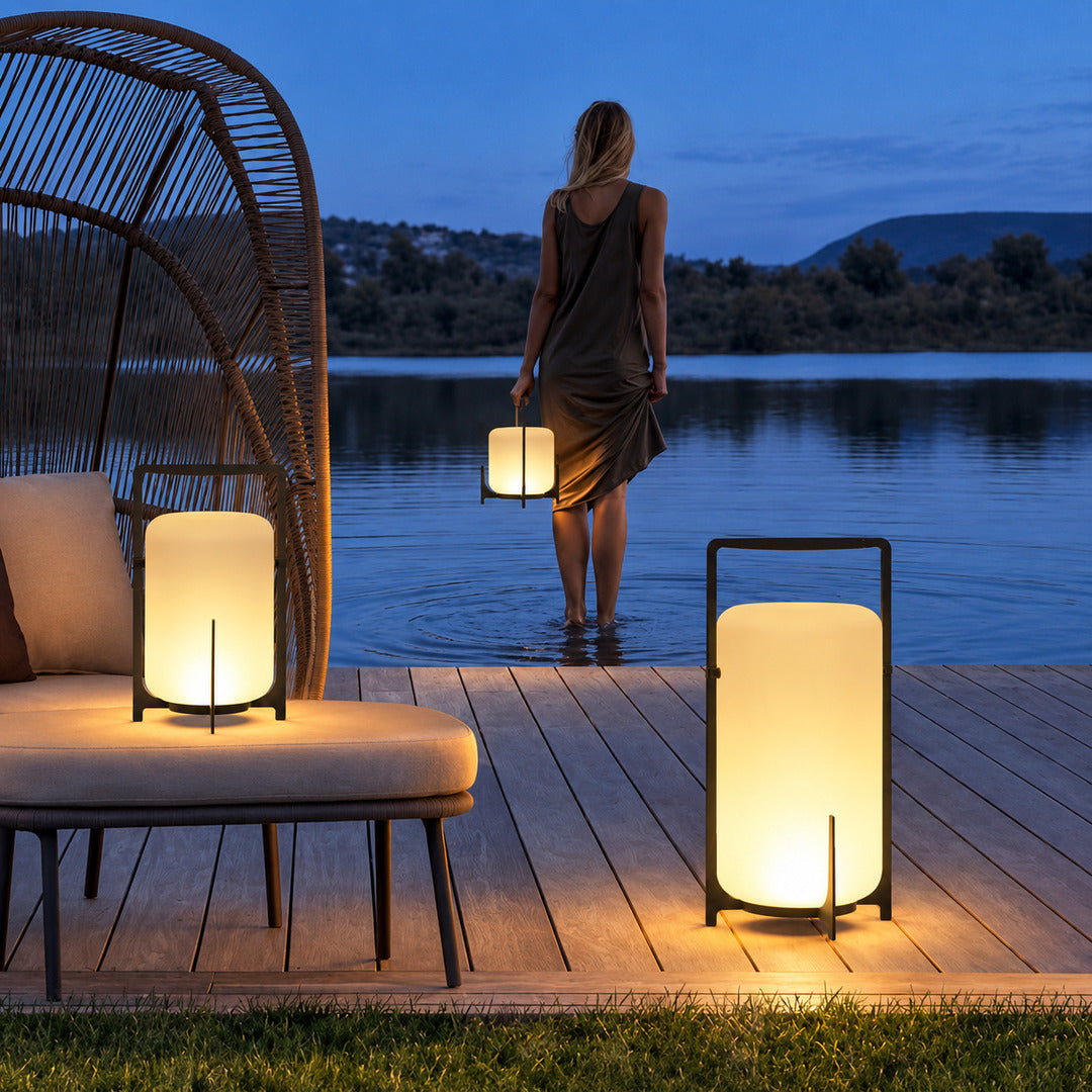 Lucciola rechargeable lanterns lining an outdoor dining table for an evening gathering