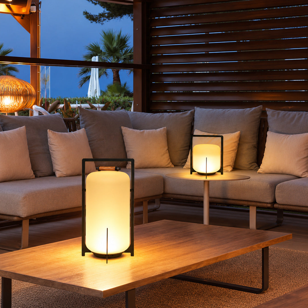 Lucciola rechargeable lanterns lining an outdoor dining table for an evening gathering