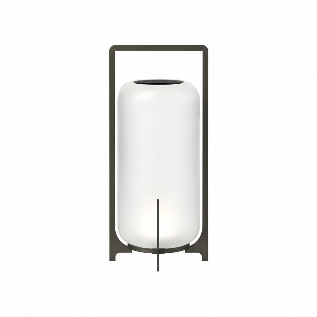 Large 21.3-inch black Lucciola rechargeable floor lantern with a glass shade beside a lounge chair