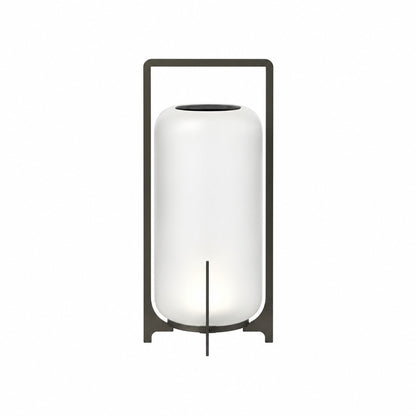 Large 21.3-inch black Lucciola rechargeable floor lantern with a glass shade beside a lounge chair
