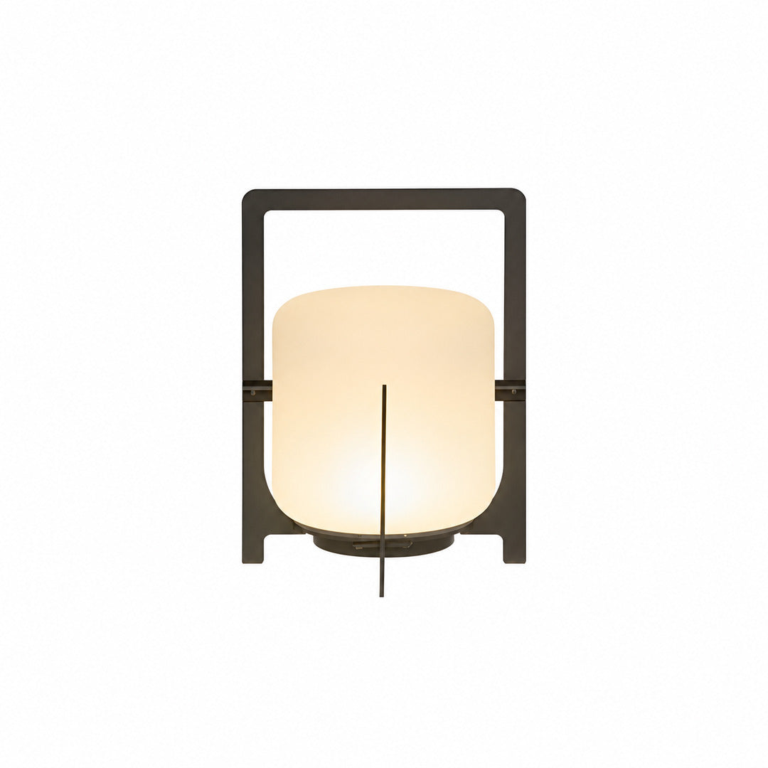 Small 11-inch black Lucciola rechargeable lantern with a glass shade on a bistro table